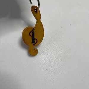 A twelve centimeters yellow treble clef keychain